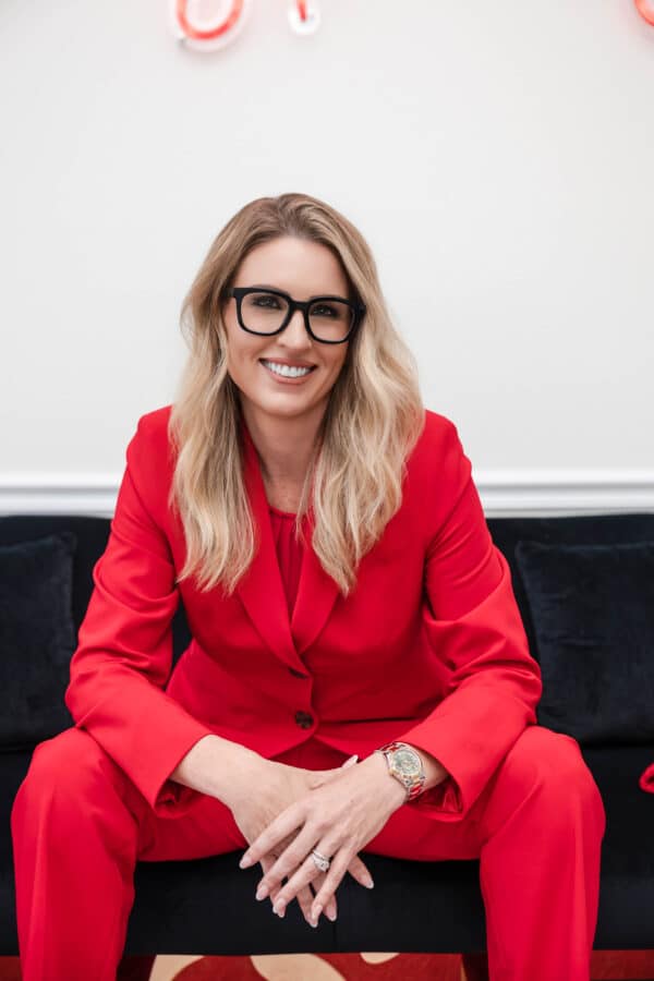 Attorney Karly Christine of Christine Law, P.A. in a red suit